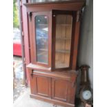 A Victorian mahogany bookcase having two glazed doors, cushion moulded drawer and two cupboard doors