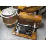 A Singer sewing machine in a domed case and a copper cased soup tureen