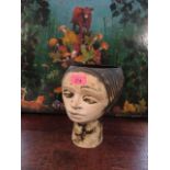 An Andre Loret Devonware vase in the form of a head