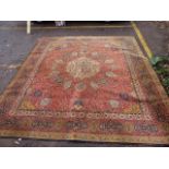 A machine made carpet with floral designs on a brown background 125" x 107"