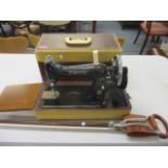 A 1958 Singer sewing machine in case, serial number EN16991, together with a field stick seat