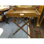 A late Victorian mahogany butlers' tray on folding stand