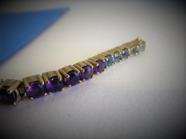 A 9ct gold articulated bracelet set with thirty eight coloured stones, 18.7g, total - Image 2 of 5