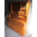 A modern pine display dresser with three drawers and four cupboard doors below 72"h x 61"w