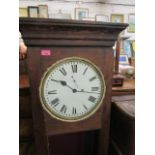 A pine cased regulator clock with a visible pendulum