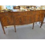 A reproduction serpentine fronted mahogany sideboard with keys