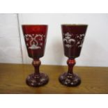 A pair of late 19th century red and gilt glass pedestal vases