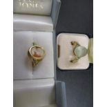 Two gold coloured rings, one set with an aquamarine coloured stone and the other a cameo