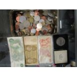 A selection of coins from around the world, a J Page £1 British note and two other banknotes