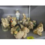 A collection of 14 composition pig figures and an early 20th century bisque figure of a young boy