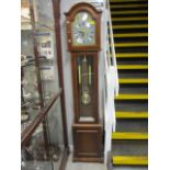 A reproduction long case clock having arched dial and glazed door 73"h