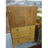 A walnut side cupboard having twin doors above three long drawers on cabriole bracket feet