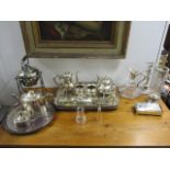 Silver plated tableware to include a tea set, a spirit kettle, a claret jug, a sugar caster, a