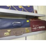 A retro Qantas passenger bag, a small Singapore Airlines case and two other bags