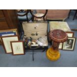 A black suitcase containing mixed items including a glass bowl, wooden containers, a jardiniere,