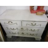 A 19th century French style white painted chest of two short and two long drawers having gilt