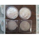 Two 2013 USA Walking Liberty one-dollar silver coins, an 1890 USA silver Morgan one-dollar coin, and