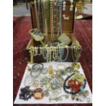 A quantity of costume jewellery to include hardstone rings and beaded necklaces, together with a