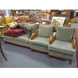 A 1930s walnut Bergere with green triangular patterned cushions, on ball and claw feet