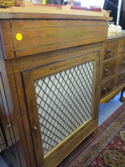 An early 20th century walnut chiffoniere having side doors and one central door below a single