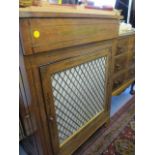 An early 20th century walnut chiffoniere having side doors and one central door below a single