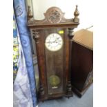 An early 20th century mahogany cased Vienna wall clock, with a white enameled dial