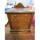 An late Victorian/early 20th century miniature chest of two short and three long drawers,