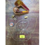 A silver watch chain with T-bar, various charms, watch key, cased pipe and other items