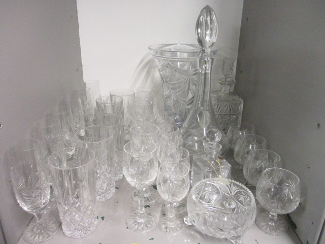 A good collection of cut glassware to include a fluted vase, a claret jug, a decanter and tumblers