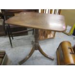 A Georgian mahogany tilt top occasional table having a turned column and splayed legs 28" H x 25 1/