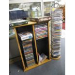 A selection of DVDs and CDs, together with two stands and a pine high chair