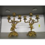 A pair of 19th century ormolu, figural garnitures, candelabras decorated with a male musician and