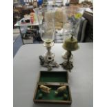 A pair of wheel engraved glass storm lanterns on silver plated bases, a brass desk bell, a silver