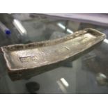 A reproduction white metal Chinese boat currency