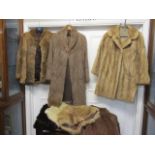 A musquash three quarter length coat, a brown rabbit jacket, a faux fur shawl, a musquash wrap, a