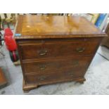 A mid 20th century walnut three drawer chest of drawers having a brushing slide and bracket feet,