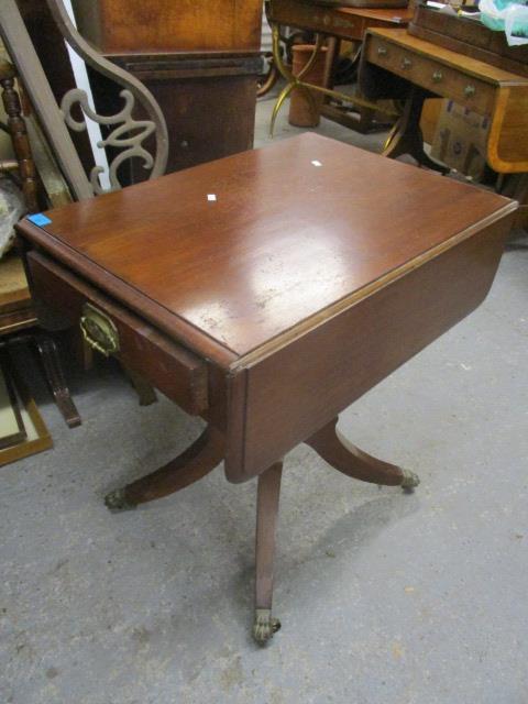 A 19th century mahogany Pembroke table having a single inset drawer and four splayed legs, 29" h x