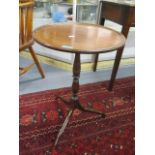 A Regency mahogany circular topped occasional table, standing on three splayed legs, 25"h x 16 1/4"w