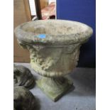 A weathered reconstituted stone urn, 26" h