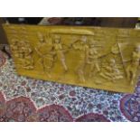 A South East Asian carved hardwood panel depicting scenes from a feast