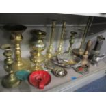 A mixed lot of metalware to include brass candlesticks, a miners lamp and other items,