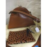 A vintage brown leather handbag, together with a Mbojo leather and spotted fur zip pouch