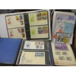 Two commemorative stamp albums containing first day covers, together with an album containing Disney