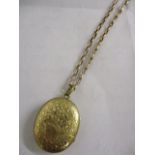 A gold coloured chain and locket