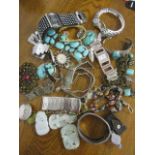 A mixed lot of mainly costume jewellery to include turquoise inset bangles, a Venetian beaded