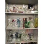 A large selection of glassware to include a silver plated Tantalus, decanters, wine glasses, vases