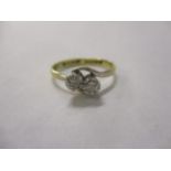 An 18ct gold and platinum diamond, two stone cross-over ring