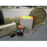 A selection of brassware and cameras to include an army brass name plate, possibly Royal Marines,