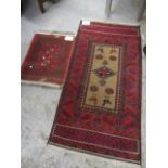 A Persian mat together with a modern red ground rug having central medallion, surrounded by birds