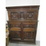 An early 20th century carved oak side cupboard, 73" x 54" x 23 2/8"